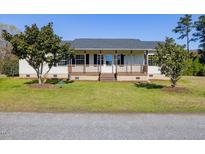 Charming ranch-style home with a covered front porch and well-maintained lawn at 79 John Horton Rd, Apex, NC 27502