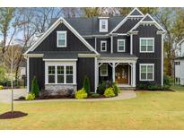 Beautiful two-story home showcasing manicured lawn and stone accents at 8201 Southmoor Hill Trl, Wake Forest, NC 27587