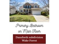 Charming two-story home with a well-manicured lawn and inviting front porch at 9117 Cornwell Dr, Wake Forest, NC 27587