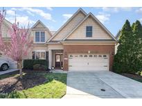 Charming two-story home with a brick and shingle facade, well-maintained lawn, and a two-car garage at 109 Aisling Ct, Cary, NC 27513