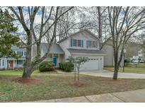 Charming two-story home featuring light gray siding, a blue front door, and a two-car garage at 110 Sudbury Ln, Chapel Hill, NC 27516