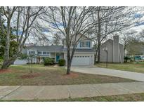 Charming two-story home featuring a well-maintained lawn and a welcoming two-car garage at 110 Sudbury Ln, Chapel Hill, NC 27516