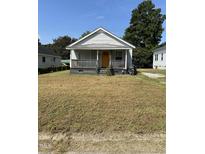 Charming single-story home featuring a welcoming porch, and a classic design at 113 Warren Ave, Oxford, NC 27565