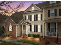 Charming two-story home features a classic design with black shutters and a welcoming front porch at 1203 Fairview Club Dr, Wake Forest, NC 27587