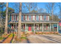 Charming two-story home with a welcoming front porch and vibrant red shutters and door at 1408 Hunters Point Way, Cary, NC 27511