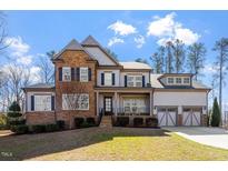 Beautiful two-story home with stone accents, neutral siding, and a well-manicured lawn at 1705 Yates Pond Way, Raleigh, NC 27606