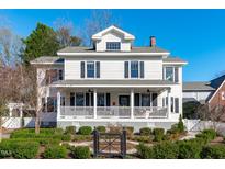Charming two-story home with a inviting front porch and beautiful landscaped front yard at 202 Duncan St, Raleigh, NC 27608