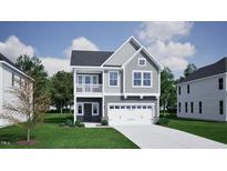 Charming two-story home with gray siding, a balcony, an attached two-car garage, and well-maintained landscaping at 247 Meadowbark Bnd # 29, Garner, NC 27529