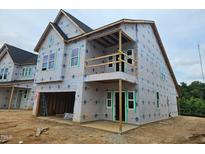 Under construction home showcasing two-story design with balcony and modern architectural elements at 247 Meadowbark Bnd # 29, Garner, NC 27529