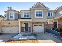 Charming townhome with brick accents, a single-car garage, and inviting front door at 2822 Casona Way, Raleigh, NC 27616