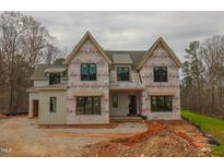 Two-story home featuring multiple windows and a modern design in the process of being built at 2916 Frances Marie Ln, Raleigh, NC 27603