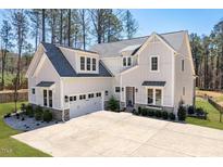Stunning new construction featuring gray siding, stone accents, and a spacious three-car garage at 298 Bonterra Way, Chapel Hill, NC 27516