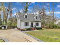 Charming home featuring a well-manicured lawn, tidy landscaping, and a welcoming driveway at 305 Dickens Rd, Fuquay Varina, NC 27526