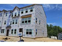 Three-story townhome under construction with multiple windows and blue sky at 340 Chesapeak Commons St # 139, Garner, NC 27529