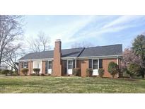Charming single-story brick home featuring a classic design and well-maintained landscaping at 421 Banks St, Graham, NC 27253