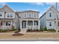 Charming two-story home with a welcoming front porch and well-maintained landscaping at 662 Vine Pkwy, Pittsboro, NC 27312