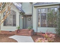 Charming home featuring a brick staircase, a wreath on the front door, and lush landscaping at 1 Bland Spring Pl, Durham, NC 27713