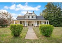 Charming two-story home with inviting front porch and well-manicured lawn at 102 Whitaker St, Franklinton, NC 27525