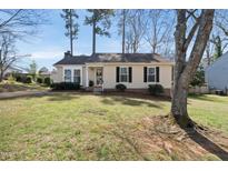 Charming single-story home featuring a well-manicured lawn and a welcoming front entrance at 103 Willoughby Ln, Cary, NC 27513