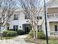 Inviting condo exterior with well-maintained landscaping, painted brick and sidewalk to entrance at 1301 Durlain Dr # 108, Raleigh, NC 27614