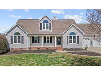 Charming home featuring a welcoming front porch, well-manicured lawn, and classic architectural details at 1408 Harvey Johnson Rd, Raleigh, NC 27603