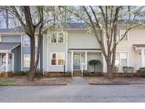 Charming townhome featuring a landscaped front yard and a welcoming covered front porch at 1515 Edgeside Ct, Raleigh, NC 27609