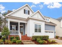 Charming home exterior with manicured landscaping, brick stairs, and a welcoming front porch at 1564 Highpoint St, Wake Forest, NC 27587