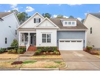 Charming two-story home featuring a two-car garage, complemented by a landscaped yard and inviting curb appeal at 1564 Highpoint St, Wake Forest, NC 27587