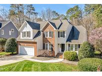 Charming two-story home with brick accents, a well-manicured lawn, and a two-car garage at 207 Alumni Ave, Durham, NC 27713