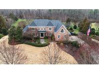Stunning brick home with well manicured lawn, mature landscaping, and a stately presence at 212 Whirlaway Ln, Chapel Hill, NC 27516