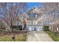 Charming home with a two-car garage and beautiful blossoming trees in the front yard at 2418 Summit Dr, Hillsborough, NC 27278