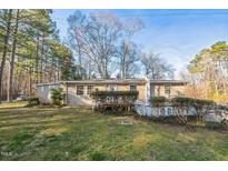 Cozy home with a well-maintained lawn and mature trees, offering a peaceful suburban setting at 3012 Optimist Farm Rd, Apex, NC 27539