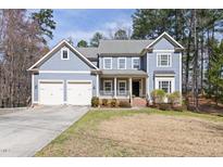 Charming two-story home with a well-manicured lawn, attached two car garage, and inviting front porch at 3541 Rugby Rd, Durham, NC 27707