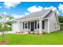 Charming single-story home with gray siding, black shutters, a well-manicured lawn, and attached garage at 385 Dasu Dr, Clayton, NC 27520