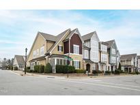 Charming multi-colored townhomes with landscaped yards and sidewalks on a sunny street corner at 525 Fallon Grove Way, Raleigh, NC 27608