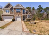 Beautiful two-story townhome featuring a stone facade, attached garage, and manicured landscaping at 5433 Jessip St, Morrisville, NC 27560