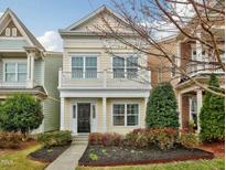 Charming two-story home with a welcoming front porch and professionally landscaped yard at 992 Ambergate, Apex, NC 27502