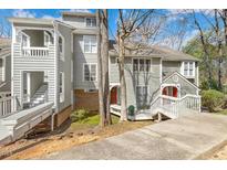 Charming townhome featuring a welcoming walkway and a traditional facade with muted neutral colors at 100 Hunting Chase # 1-B, Cary, NC 27513