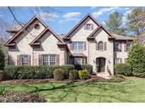 Beautiful, two-story brick home with well-manicured landscaping and a charming, inviting facade at 10841 Round Brook Cir, Raleigh, NC 27617