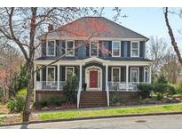 Charming two-story home featuring a welcoming front porch and beautifully landscaped front yard at 111 Parkside Cir, Chapel Hill, NC 27516