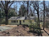 Charming single-story home featuring a well-maintained yard and mature trees at 123 Barclay Rd, Chapel Hill, NC 27516