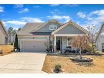 Charming single-Gathering home with a well-maintained lawn, attached garage, and inviting curb appeal on a sunny day at 123 Carbone Ln, Clayton, NC 27527