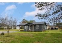 Charming single-story home featuring a covered carport and a well-maintained, green front lawn at 1239 Brogden Rd, Smithfield, NC 27577