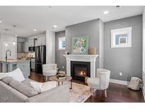 Inviting living room featuring a fireplace, modern furniture, and an open floor plan at 1312 Big Falls Dr, Wendell, NC 27591