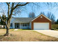 Charming single-story home with brick accents, a covered porch, and attached two-car garage at 1930 Maple Sugar Ln, Fuquay Varina, NC 27526