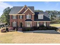Beautiful brick home with manicured lawn, black shutters, and a classic architectural style at 2324 Baileys Landing Dr, Raleigh, NC 27606