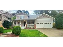 Charming two-story home featuring a well-manicured lawn and a two-car garage at 2429 Falls River Ave, Raleigh, NC 27614