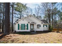 Charming single-story home featuring a well-maintained yard and lush surrounding trees at 2776 Jordan Ct, Creedmoor, NC 27522