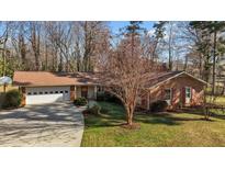 Charming brick home featuring an attached two-car garage and a well-manicured lawn at 3001 Blanche Dr, Burlington, NC 27215
