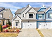 Charming home featuring a two-car garage, tidy landscaping, and Craftsman-style architecture at 3162 Retama Run # 231, Apex, NC 27562